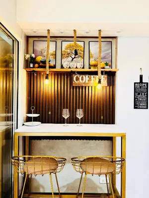a restaurant with two chairs and a counter with glasses at Azure Staycation by Via Sabby in Manila