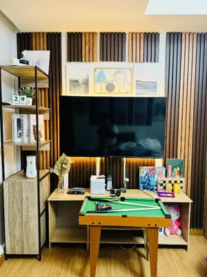 a room with a ping pong table and a tv at Azure Staycation by Via Sabby in Manila