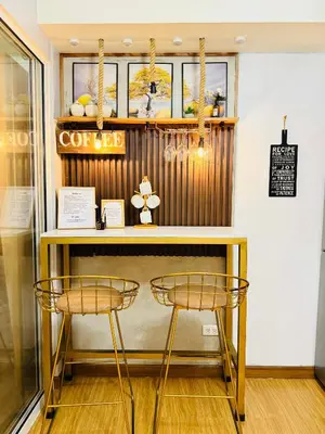 a counter with two stools in a store window at Azure Staycation by Via Sabby in Manila