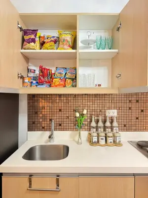 a kitchen counter with a sink and some food at Azure Staycation by Via Sabby in Manila