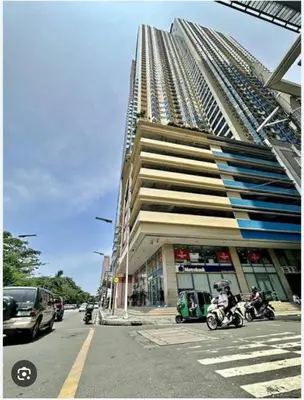 a tall building with motorcycles parked in front of it at Condo In front of US Embassy Studio Unit with 2 Double Beds in Manila
