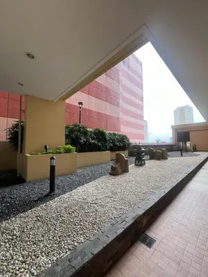 a building with a walkway in front of a building at Condo In front of US Embassy Studio Unit with 2 Double Beds in Manila
