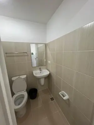 a bathroom with a toilet and a sink at Condo In front of US Embassy Studio Unit with 2 Double Beds in Manila