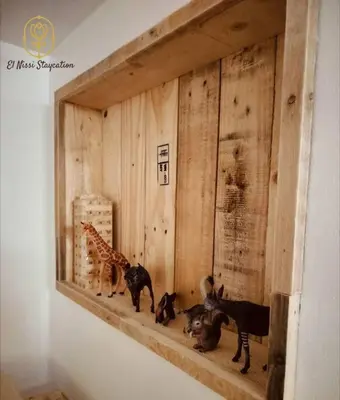 a wooden shelf with three animals on a wall at El Nissi Staycation, The Play Cabin, Beside Enchanted Kingdom in Santa Rosa