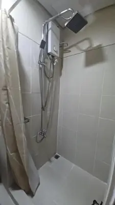 a shower in a bathroom with a shower at Cozy Condo Stay Near MOA in Manila