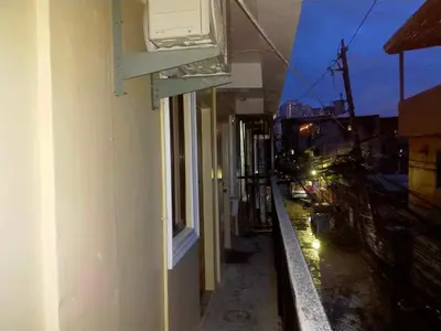 a window on a building with a view of a street at Bahay ni Ate Rose in Manila