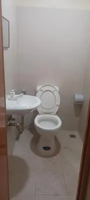 a bathroom with a toilet and a sink at Bahay ni Ate Rose in Manila