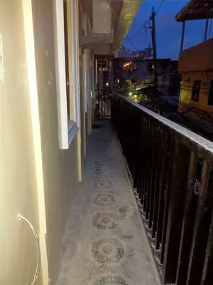 a hallway of a building with a balcony at Bahay ni Ate Rose in Manila