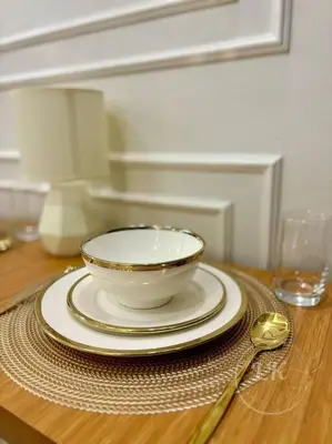 a bowl and plates on a table with a spoon at Design And Den - LK Urban Suites in Manila
