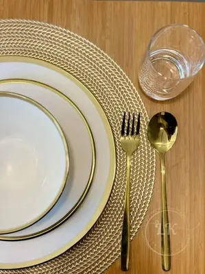 a table with two plates and a fork and a glass at Design And Den - LK Urban Suites in Manila