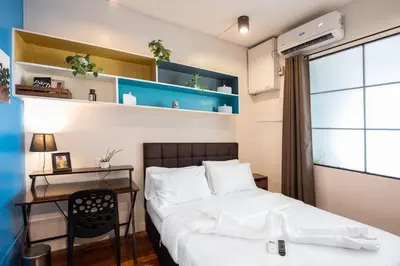 a bedroom with a bed and a desk at Homey and Cozey Poblacion Makati S07 in Manila