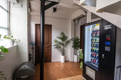 a room with a soda vending machine and a door at Homey and Cozey Poblacion Makati S08 in Manila