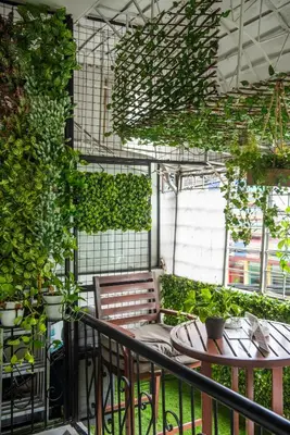 a balcony with a table and chairs and plants at Homey and Cozey Poblacion Makati S09 in Manila