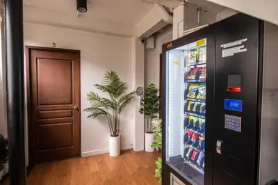 an office with a soda vending machine and a door at Homey and Cozey Poblacion Makati S10 in Manila