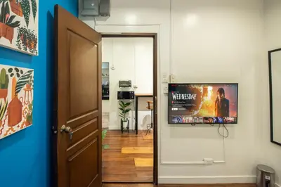 a room with a flat screen tv on a wall at Homey and Cozey Poblacion Makati S11 in Manila
