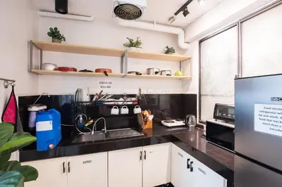 a kitchen with a sink and a refrigerator at Homey and Cozey Poblacion Makati S11 in Manila