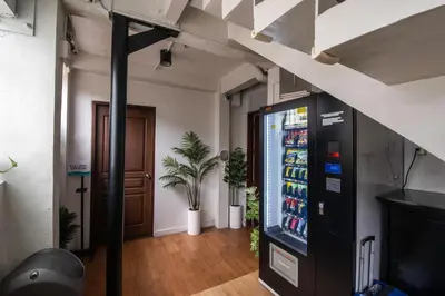a drink vending machine in a room with a door at Homey and Cozey Poblacion Makati S12 in Manila