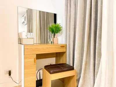 a stool in front of a vanity with a mirror at Elegant Venice Condo Mckinley Hill BGC #vlrtc5i in Manila