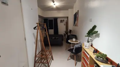 a living room with a ladder and a couch at Calicon Suites in Manila