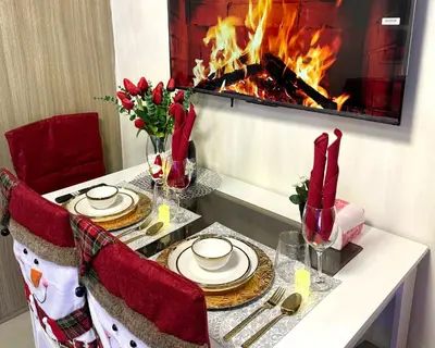 a dining room table with a fireplace in the background at Santa Place Shore Residences Tower A in Manila