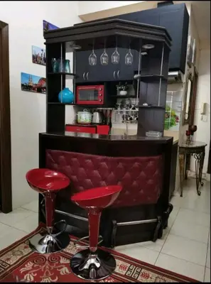 a bar with two red stools in a kitchen at Sweetheart Casa Vacanza in Manila