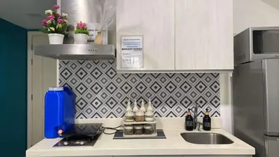 a small kitchen with a sink and a counter top at Cozy Inn Azure in Manila