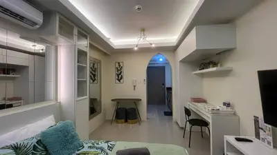 a living room with a couch and a table in a room at Shore 2 Residences by Casa Stellar in Manila