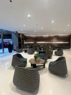 a lobby with chairs and tables in a building at Shore 2 Residences by Casa Stellar in Manila