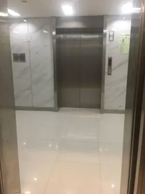 a bathroom with a glass door and a white tile floor at A & Y Staycation in Manila