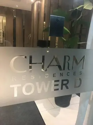 a sign in a store window with a plant at A & Y Staycation in Manila