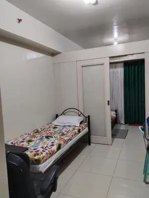 a bedroom with a bed in a room at Sea Residences MOA by -MJ in Manila