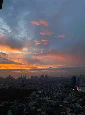 a view of a city with a sunset in the sky at Amazing 1 bedroom with pool, gym and stunning view at heart of Makati in Manila