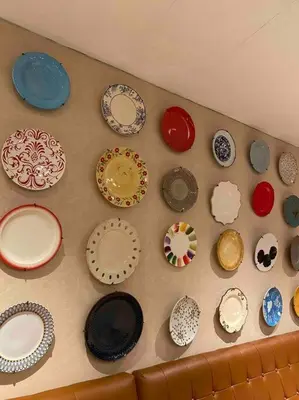 a bunch of plates are on a wall at Amazing 1 bedroom with pool, gym and stunning view at heart of Makati in Manila