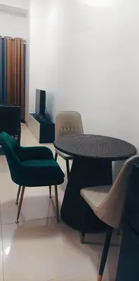 a room with a table and two chairs and a table at Natalie's Place in Mall of Asia Complex in Manila