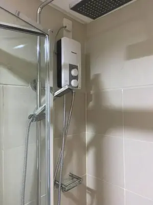 a shower in a bathroom with a glass shower stall at 1BR CONDO Fame Residences Mandaluyong- Be My Guest Staycation- Near SM Megamall, Greenfield District, & Ortigas in Manila