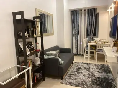 a living room with a couch and a table at 1BR CONDO Fame Residences Mandaluyong- Be My Guest Staycation- Near SM Megamall, Greenfield District, & Ortigas in Manila