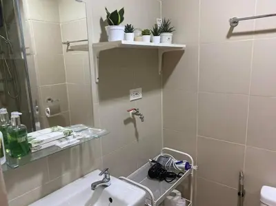 a bathroom with a sink and a mirror at 1BR CONDO Fame Residences Mandaluyong- Be My Guest Staycation- Near SM Megamall, Greenfield District, & Ortigas in Manila