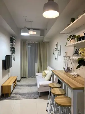 a living room with a couch and a table at Twin Duckworth Suites T1 in Manila