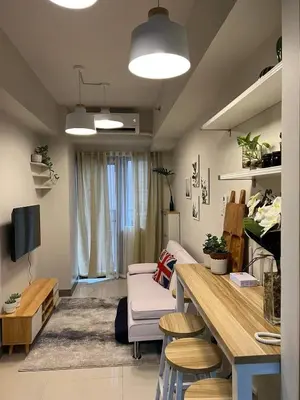 a living room with a couch and a table at Twin Duckworth Suites T1 in Manila
