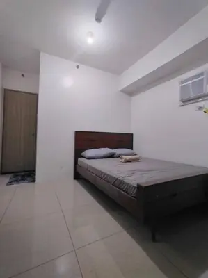 a bedroom with a bed in a white room at Spacious 2-BR Condo - Shore Residence Tower D - Walking distance to Moa in Manila