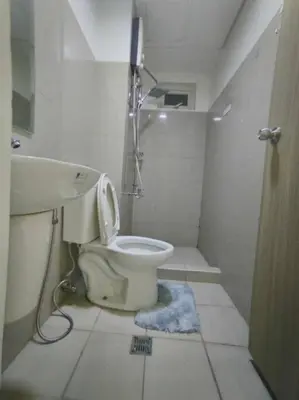 a small bathroom with a toilet and a shower at Spacious 2-BR Condo - Shore Residence Tower D - Walking distance to Moa in Manila