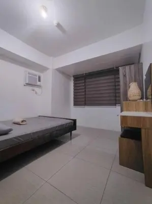a bedroom with a bed and a window in it at Spacious 2-BR Condo - Shore Residence Tower D - Walking distance to Moa in Manila
