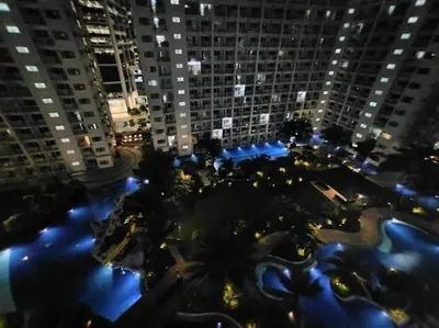 an aerial view of a city at night with buildings at Spacious 2-BR Condo - Shore Residence Tower D - Walking distance to Moa in Manila