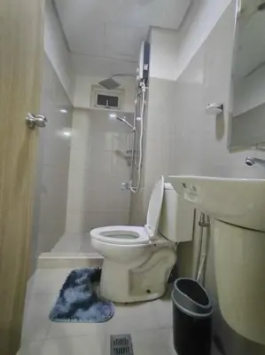 a bathroom with a toilet and a shower and a sink at Spacious 2-BR Condo - Shore Residence Tower D - Walking distance to Moa in Manila