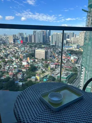 a table with a view of a city at Cozy 1 bedroom condo in Uptown BGC in Manila