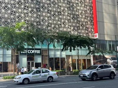 two police cars parked in front of a building at Cozy 1 bedroom condo in Uptown BGC in Manila