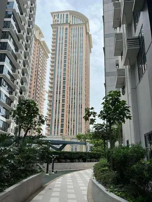 a walkway in a city with tall buildings at The Viceroy Tower1 condominium in Manila