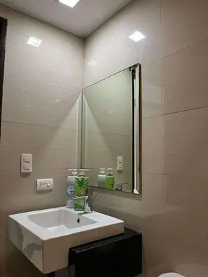 a bathroom with a sink and a mirror at The Viceroy Tower1 condominium in Manila
