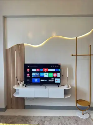 a flat screen tv sitting on top of a white shelf at Haiya's Staycation Aesthetic & Cozy in Tagaytay in Biluso