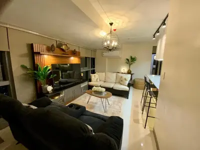 a living room with a couch and a table at Luxurious 2 BR at Eastwood City in Manila